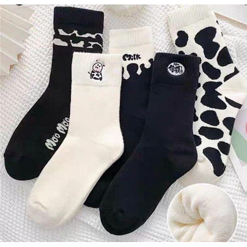 Warm fleece lined winter sock set featuring a vibrant black and white dairy cow design