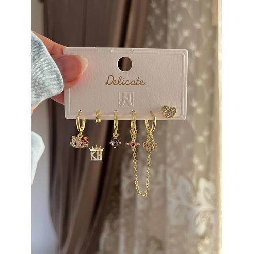 set of six gold-plated hoop and drop earrings featuring various charms and cubic zirconia stones.