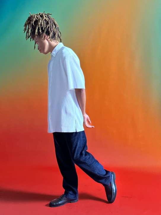 A photo of a man in front of a colorful wall. The shot was taken with the new 2x Telephoto.