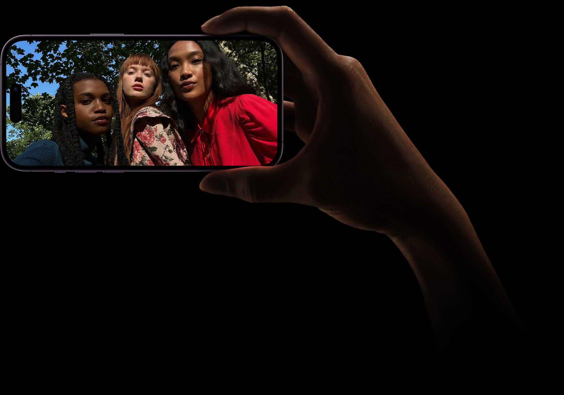 A group selfie of three women posing together. The photo was taken on the TrueDepth camera.