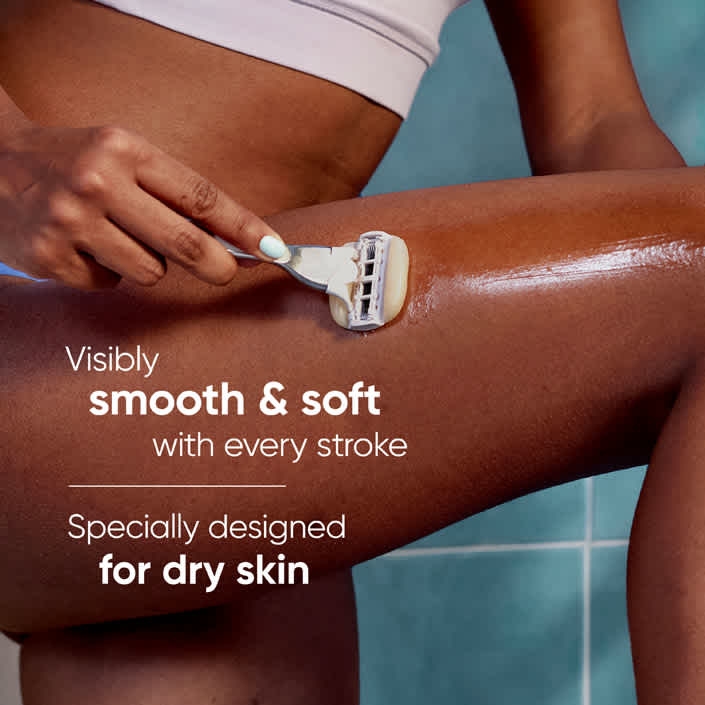 Lady shaving her leg in the bathroom, using Venus MoistureGlide with Argan oil without the shaving gel.