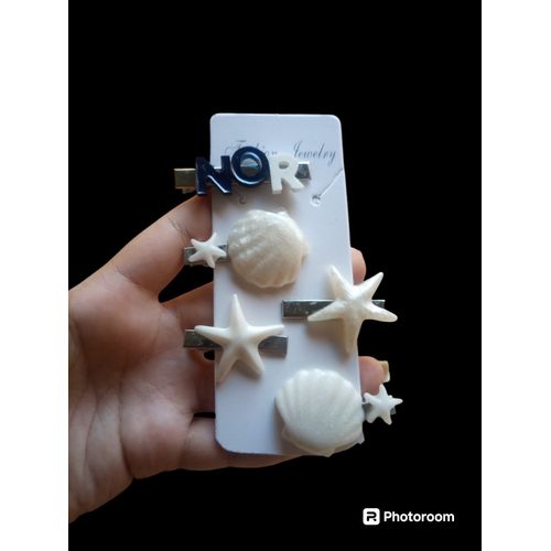 Five Pieces Of Handmade Resin Hair Scrunchies In The Shape Of Shells And Stars, With Shells And The Name Nour