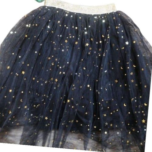 A tulle skirt decorated with stars and crescent moons, suitable for ages 5 to 10.