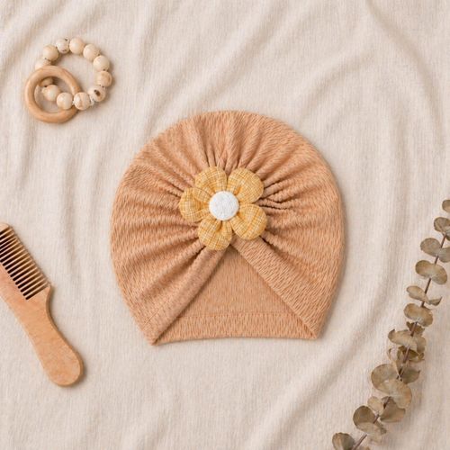 An elegant flower-adorned turban hat for infants a practical, flexible, and delicate baby turban. This ready-to-wear headpiece is perfect for newborns and baby girls an ultra-soft and stretchy baby headband.