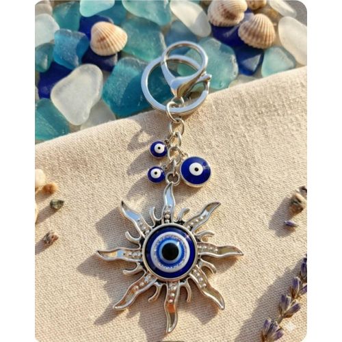 Evil Eye Sun Keychain Add a stylish touch to your keys or bag with this eye-catching Evil Eye Sun Keychain