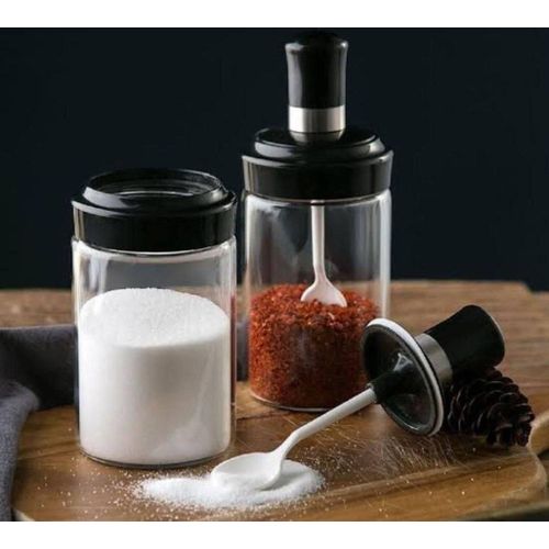 Glass jar with a spoon for kitchen spices, one piece