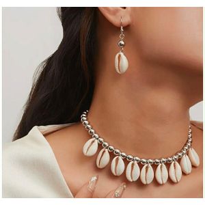 Bracelets A stunning jewelry set featuring a choker necklace and matching earrings, perfectly blending polished silver beads with natural cowrie shells.