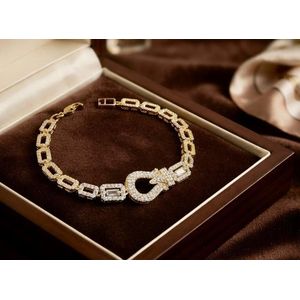 A bracelet made of genuine stainless steel  plated with 18 karat gold and set with diamond like stones  it is rust resistant and looks exactly like real gold. Comes with a gift box and bag.