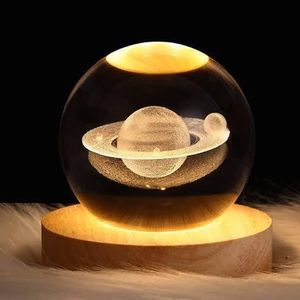 3D spherical crystal ball with a Saturn design and wooden base