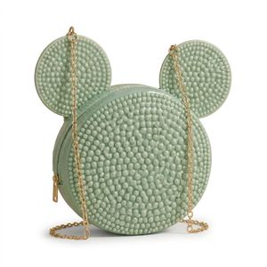 A distinctive round crossbody bag in light green, adorned with elegant embossed details and a gold chain.