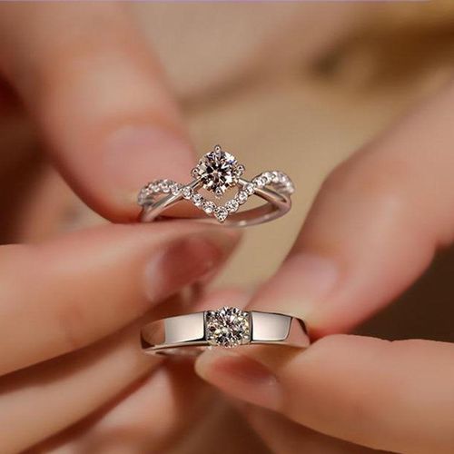 hands of a young couple with a ring. love, couple, relationship and  holidays concept - close up of man giving diamond ring to woman Stock Photo  | Adobe Stock