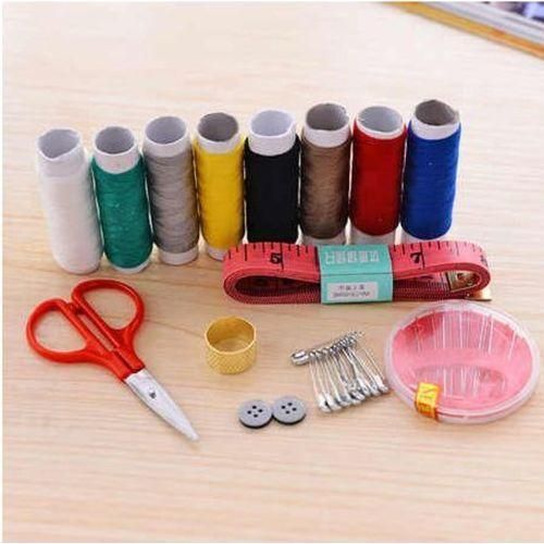 A Box Of Multi-colored Thread Spools + Sewing Needles, Scissors, And Sewing Supplies