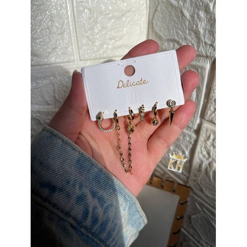 set of six gold-plated hoop and drop earrings featuring various charms and cubic zirconia stones.